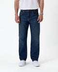The Jeans Classic Straight Fit in Mid Wash Blue — front view on a model with white sneakers