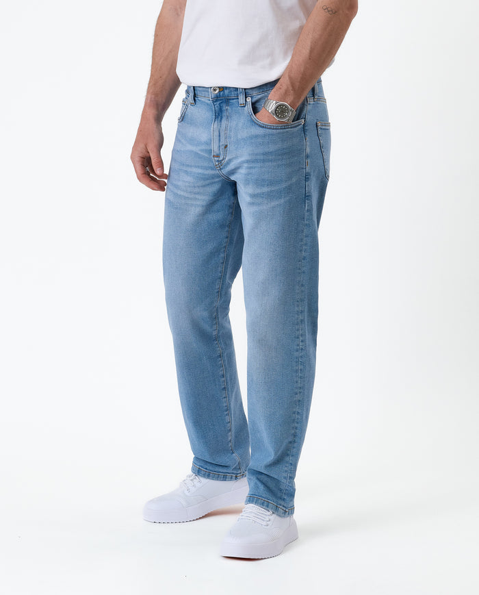 The Jeans Classic Straight Fit in light mid blue — side view worn with white sneakers