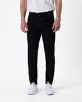 The Jeans Skinny Fit in jet black — front view worn with white sneakers