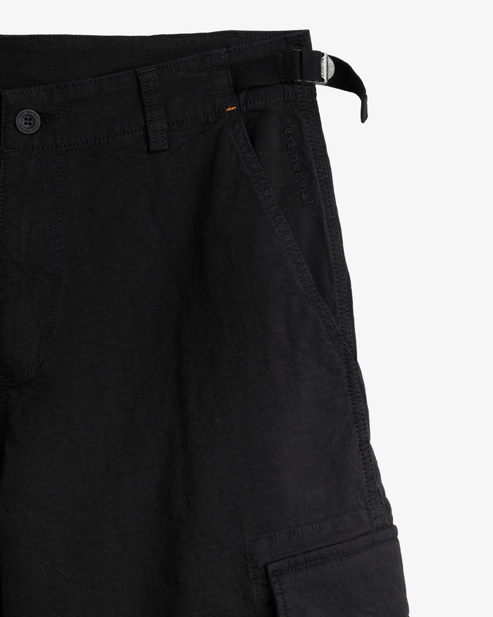 The Monterrey Cargo Pant in black — close-up of the adjustable waist and pocket embroidery