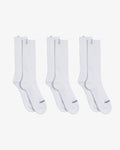 A front view of The Sock White 3-Pack, laid flat on a white background. The image highlights the three pairs of white mid-calf length socks, featuring the c'est normal logo on the cuff tag and across the toe.