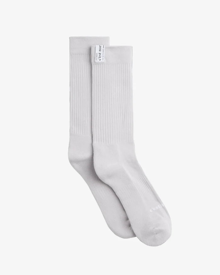 The Socks 3-pack in grey — ribbed texture with a white C'est normal logo tag.
