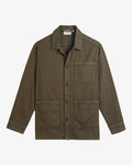 A front view of The Workwear Overshirt in olive green, laid flat on a white background. The image highlights the button-up front, patch pockets at the left chest and hips, and the c'est normal tag inside the collar.