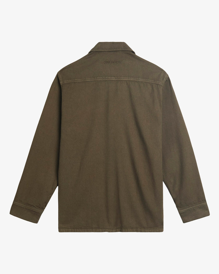 A back view of The Workwear Overshirt in olive green, laid flat on a white background. The image highlights the embroidered c'est normal logo below the collar.