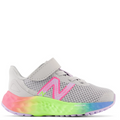 A toddler's running shoe with gray mesh upper, pink and green New Balance logo, and a multicolored rubber outsole.