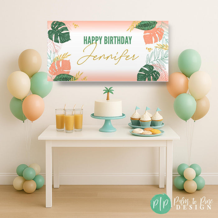 a neutral tropical birthday party dessert table and personalized banner in modern gold and coral peach color scheme