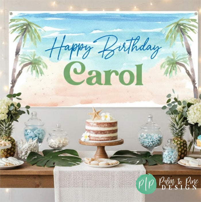 A beach themed birthday banner with a tropical scene for adults, along with a table displaying a cake, candies, and other decorations.