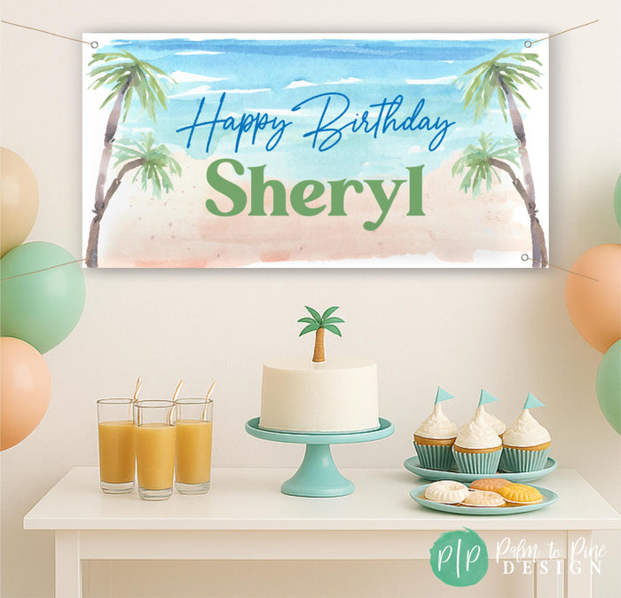 An adult birthday party setup with a banner that reads "Happy Birthday Sheryl", a cake with a palm tree topper, and various party decorations and refreshments.