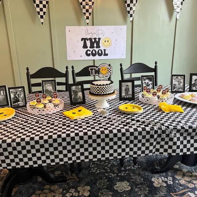 A fun and vibrant 'Two Cool' birthday banner featuring a yellow smiley face and striking lightning bolt details, with a black and white checkered modern theme.