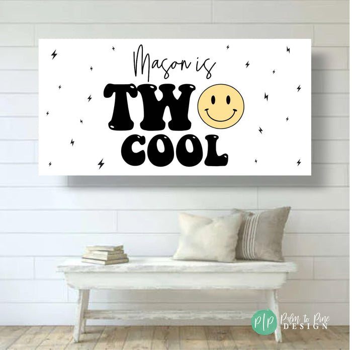 Two Cool' birthday banner with minimalist lightning bolt accents and a cheerful smiley face design on white shiplap wall