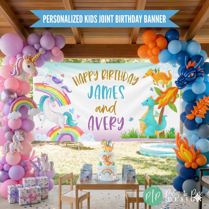 Boy girl birthday party with unicorns and dragons theme. Photo includes a personalized banner that is half unicorn and half dragon and kids names, surrounded by a unicorn themed balloon garland and dragon themed garland