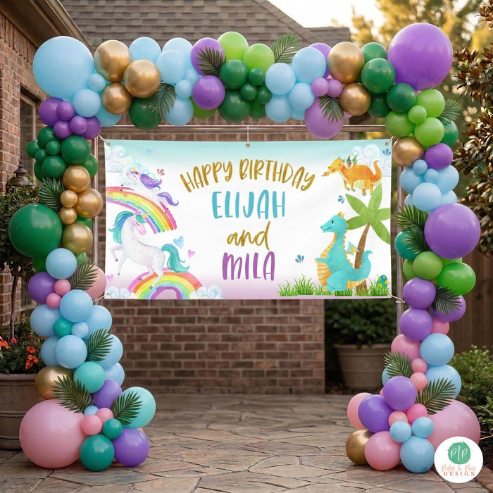 Unicorn Dragon Birthday Banner hung at entrance of party surrounded by large balloon arch