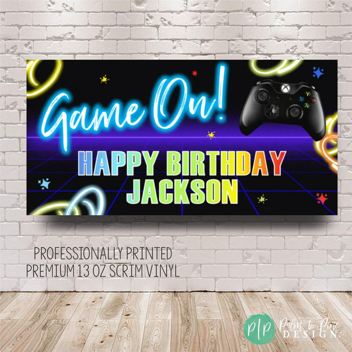 a video game birthday sign with a video game controller