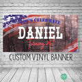 A custom vinyl banner with a rustic wood whiskey barrel background and an American flag design. The banner says 'Let's Celebrate name and age!' in white text with red and blue American Flag accents. The banner is a custom vinyl banner for a birthday party.