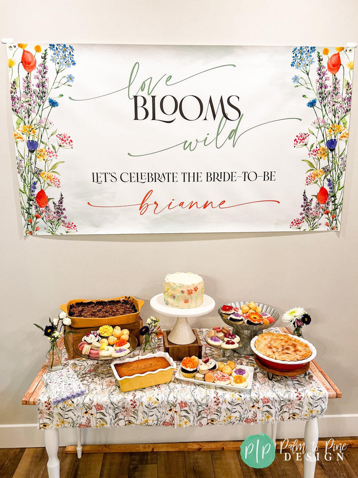 love blooms wild bridal shower banner and simple dessert table in a wildflower theme