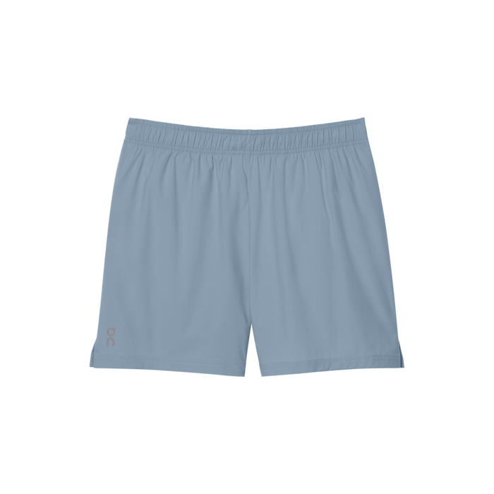 A pair of women's 5-inch core shorts in a solid blue color with an elastic waistband, side slits, and three pockets including a concealed zippered back pocket and two front pockets.