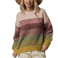 A woman wearing a chunky knit striped sweater with horizontal bands of cream, dusty rose, mauve, sage green, and mustard yellow, paired with a wide-brimmed tan hat and light beige pants, against a solid light gray studio background.