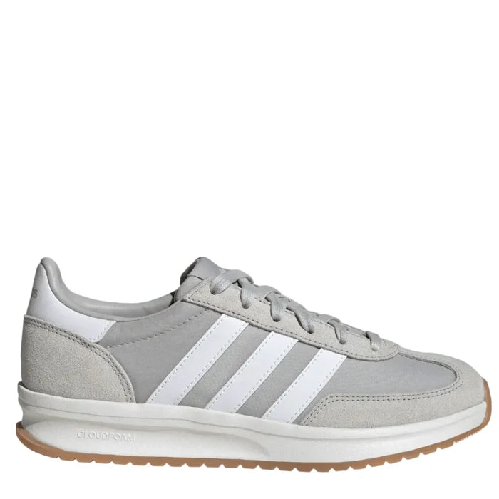Gray sneaker with white stripes on a light gray background