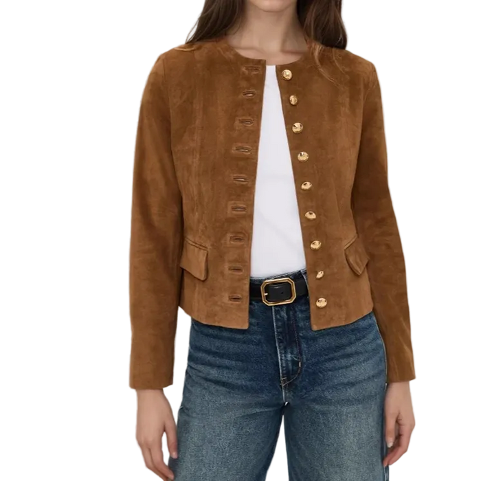 A woman wearing a cropped brown suede jacket with gold-tone decorative buttons down the front, styled over a white top and blue jeans.